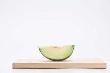Cantaloupe melon sliced on chopping board 