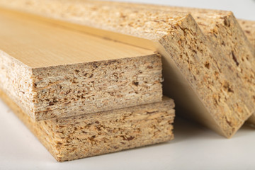 Particleboard with veneer is cut into small pieces. Materials for carpenters to build furniture.