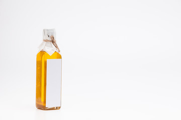 Perill oil in single glass bottle on white background