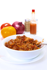 Bowl of Chicken Jambalaya on white with vegetables and spices in BG with Copy Space