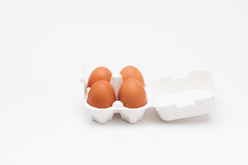  Brown eggs with white eggbox isolated on white background