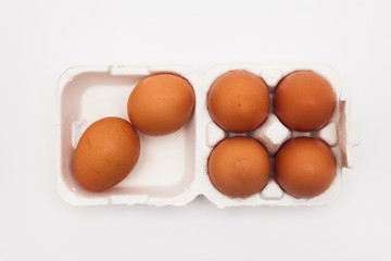 Brown eggs with white eggbox isolated on white background 