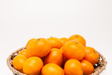 Ornage in basket isolated on white background Mandarin