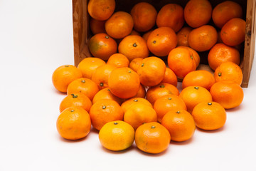Mandarin  tangerine in wooden crate isolated on white