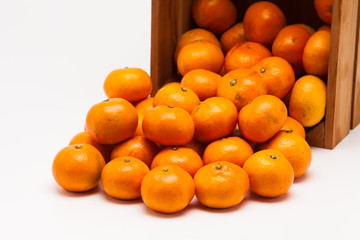 Mandarin  tangerine in wooden crate isolated on white