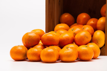 Mandarin  tangerine in wooden crate isolated on white