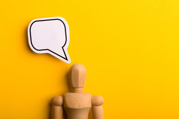 Thinking Concept With Blank Speech Bubble And Wooden Man