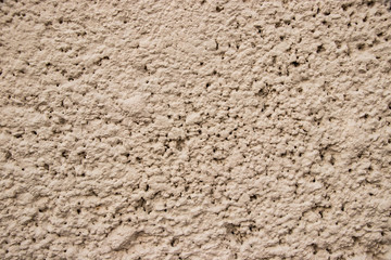 Beige stucco wall texture close up