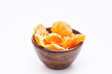 Peeled mandarin orange on wooden bowl