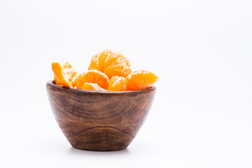 Peeled mandarin orange on wooden bowl