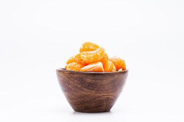 Peeled mandarin orange on wooden bowl