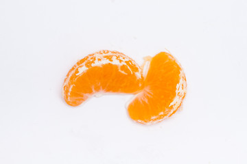 Peeled sliced mandarin in the glass form on white