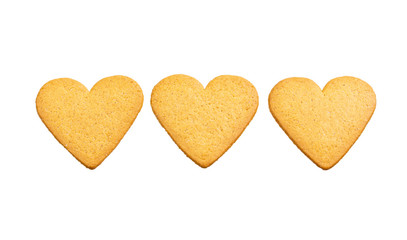 Three hearts of ginger dough cookies isolated on white background. Sweet dessert beautiful ornament pattern