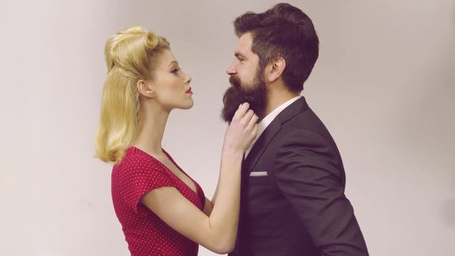 Cute man and woman wearing trendy retro vintage clothes old style. Pretty couple dressed vintage clothe making funny faces. Retro couple on grey background.