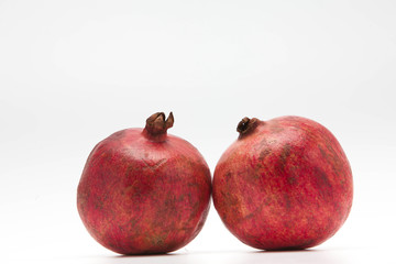 Two red pomegranate isolated on white background