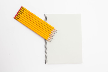 A Bunch of yellow pencil and binder notebook on white