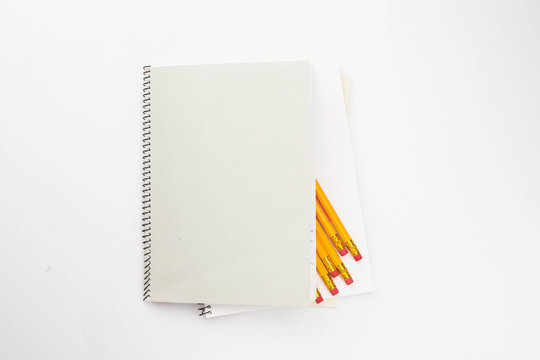 A Bunch of yellow pencil and binder notebook on white - Powered by Adobe