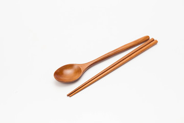 Wooden chopsticks and spoon isolated on white