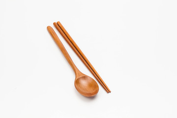 Wooden chopsticks and spoon isolated on white