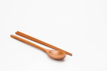 Wooden chopsticks and spoon isolated on white