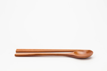 Wooden chopsticks and spoon isolated on white