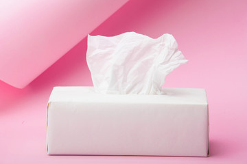White Tissue box on abstract pink background