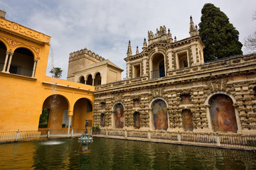 Fototapeta premium Gothic palace and Mercury pond with fountain at Royal Alcazar of Seville Andelusia Spain