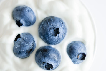 Berry background. Fresh berry blueberries and organic yogurt. Concept of healthy and diet food. Flat lay, top view, copy space