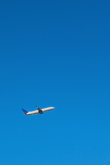 Airplane departure flying in a blue sky day