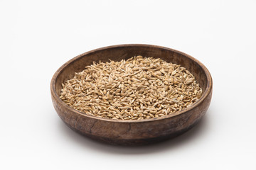 Barley grains in wooden plate isolated