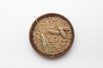  Barley grains with wheat ear on plate isolated 