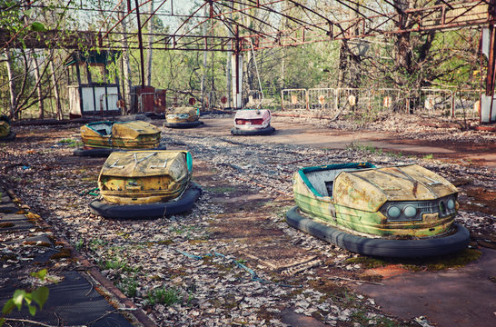 abandoned bumper cars in ruined amusement park in Pripyat city, Exclusion zone of Chernobyl, Ukraine