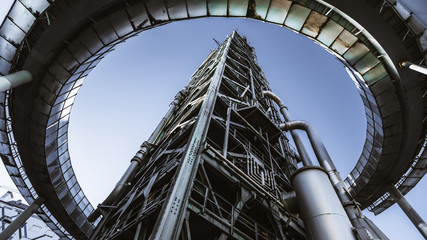 Wide angle shot from the ground of a contemporary building of an oil refinery or a modern fuel...