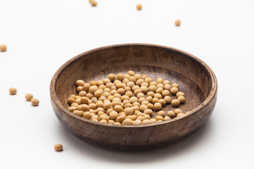 Dried soy beans in wooden bowl isolated