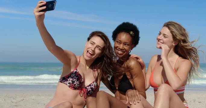 Young female friends taking selfie with phone 4k