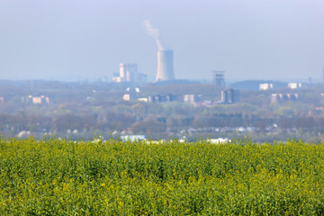 a plain field in front of a power plant