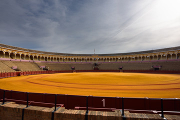 Golden groomed sand and empty stands at the Seville bullfighting ring