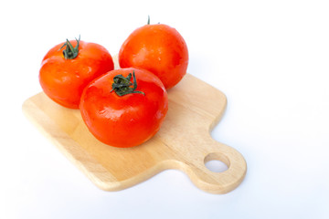 Close up red tomatoes isolated on white background.Tomatoes are vegetables that contain vitamin C and A. And also have anti-oxidants such as lycopene Beta-carotene and phosphorus as well.