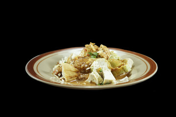 Gado-Gado Indonesian food. A mixture of tofu, rice cake, salad and spicy peanut sauce.