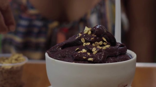 Slow Motion: Oat Topping Being Sprinkled Onto Bowl Full of Chocolate Dessert - Rio de Janeiro, Brazil