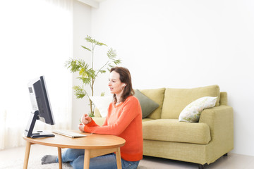 Online lesson teacher in front of computer