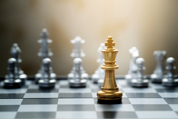 King chess game on chessboard with black background. Business and teamwork concept