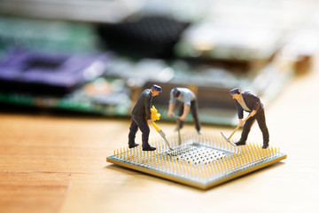 miniature people repair cpu board,teamwork and technology