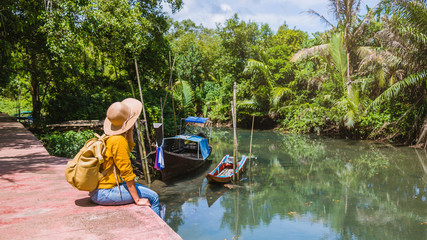 Asian woman travel nature. Travel relax.a boat photo. Sitting watching the beautiful nature at tha pom-klong-song-nam. Krabi, in Thailand.