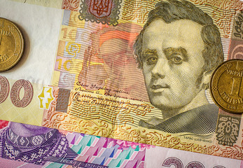 Ukrainian money. Coins in one hryvnia, bills in a hundred and two hundred hryvnia. Cash. Background...