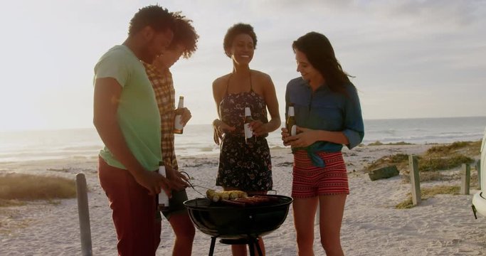 Friends cooking food on barbecue at beach 4k