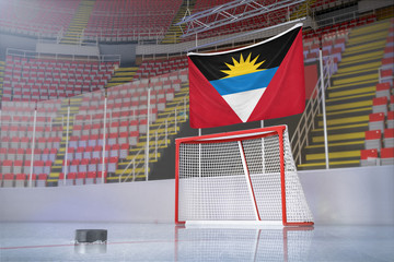 Flag of Antigua and Barbuda in hockey arena with puck and net