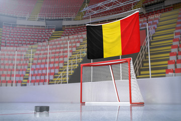 Flag of Belgium in hockey arena with puck and net