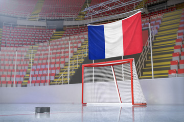 Flag of France in hockey arena with puck and net