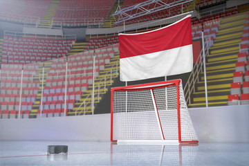 Flag of Indonesia in hockey arena with puck and net